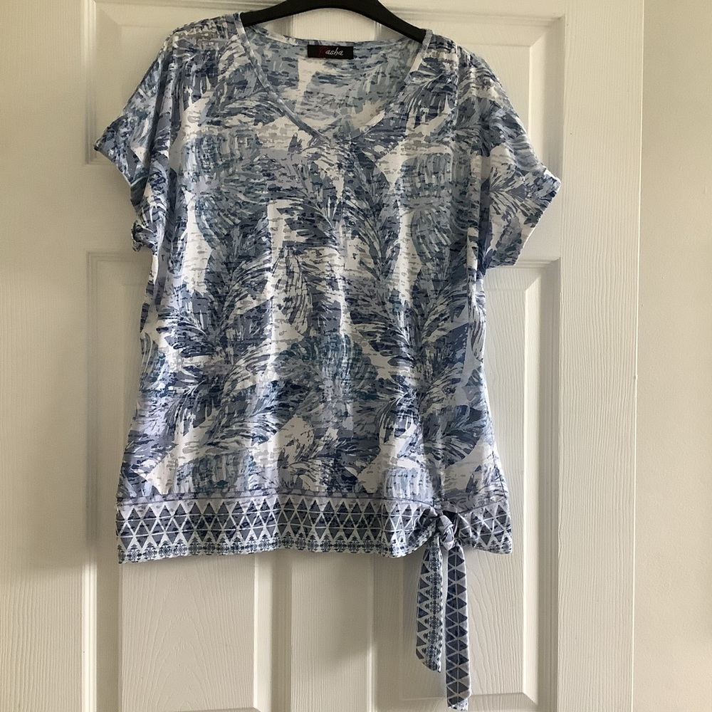 Woman’s blue and white pattern short sleeve top by Pasha.